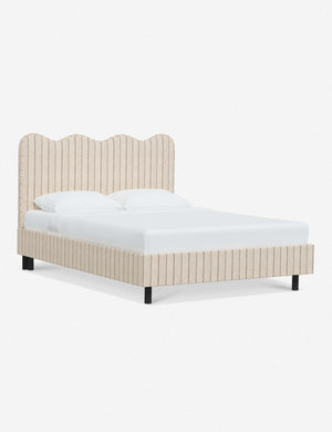 Angled view of Clementine natural stripe linen platform bed with undulating lined headboard