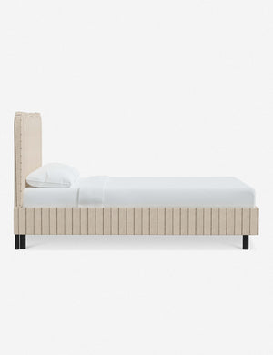 Side view of Clementine natural stripe linen platform bed with undulating lined headboard