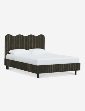 Angled view of Clementine peppercorn stripe linen platform bed with undulating lined headboard
