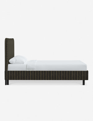 Side view of Clementine peppercorn stripe linen platform bed with undulating lined headboard