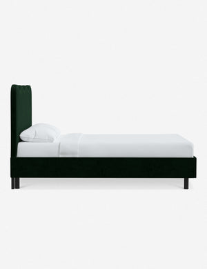 Side view of Clementine emerald velvet platform bed with undulating lined headboard