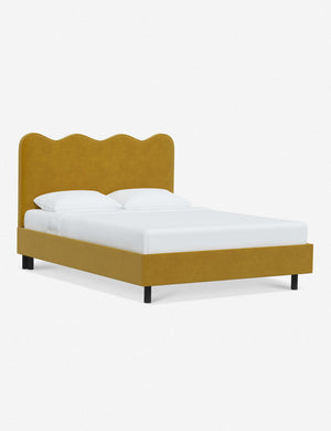 Angled view of Clementine yellow citronella velvet platform bed with undulating lined headboard