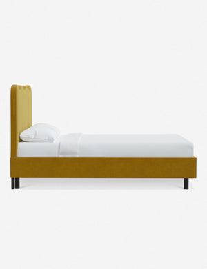 Side view of Clementine yellow citronella velvet platform bed with undulating lined headboard