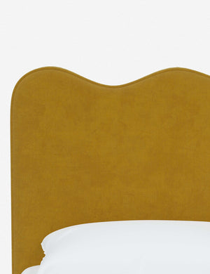 Close-up of the undulating lines on the headboard of the Clementine yellow citronella velvet platform bed