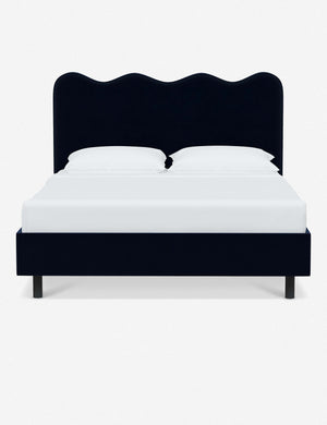 Clementine navy velvet platform bed with undulating lined headboard