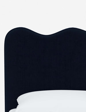 Close-up of the undulating lines on the headboard of the Clementine navy velvet platform bed