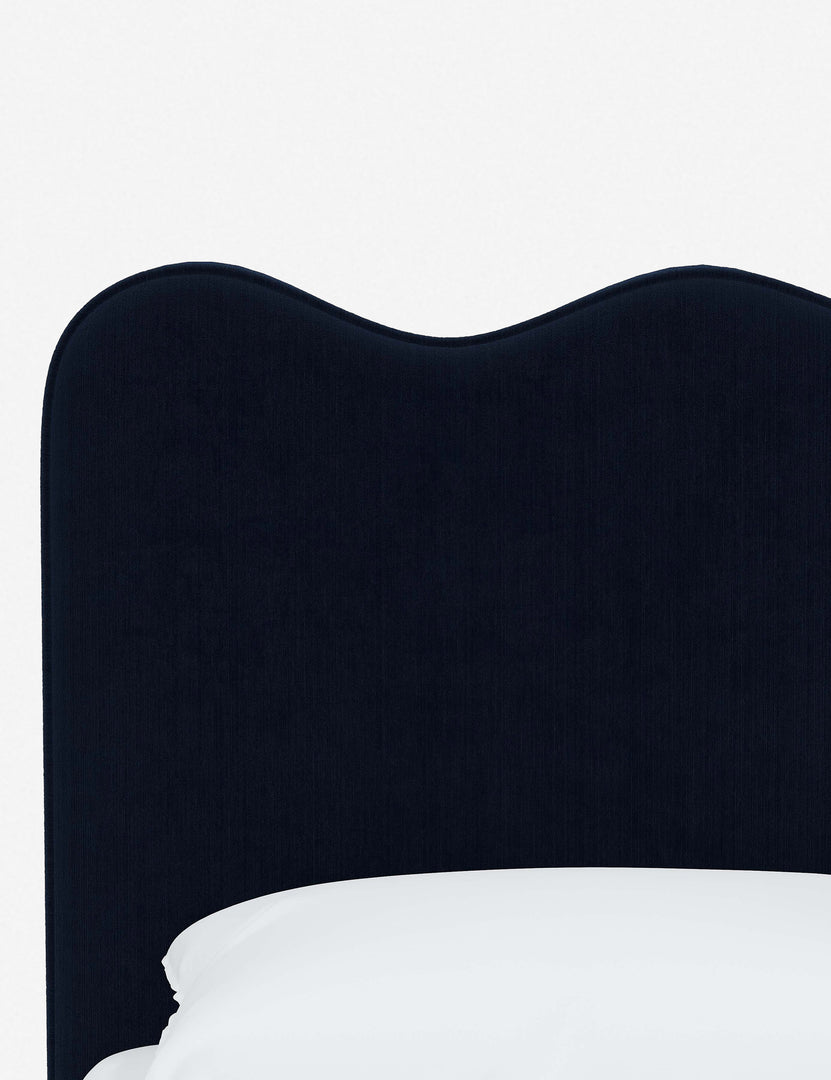 #color::navy-velvet #size::twin #size::full #size::queen #size::king #size::cal-king | Close-up of the undulating lines on the headboard of the Clementine navy velvet platform bed