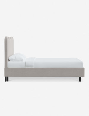 Side view of Clementine mineral velvet platform bed with undulating lined headboard