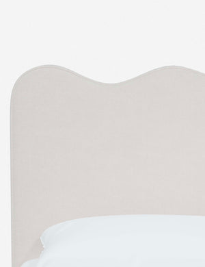 Close-up of the undulating lines on the headboard of the Clementine snow velvet platform bed