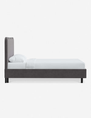 Side view of Clementine steel velvet platform bed with undulating lined headboard
