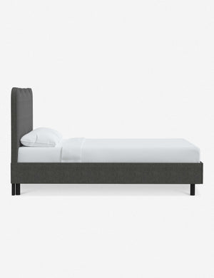 Side view of Clementine charcoal linen platform bed with undulating lined headboard