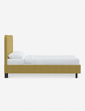 Side view of Clementine golden linen platform bed with undulating lined headboard
