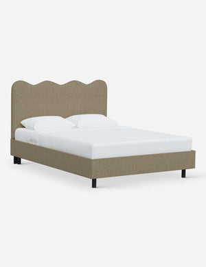 Angled view of Clementine pebble linen platform bed with undulating lined headboard