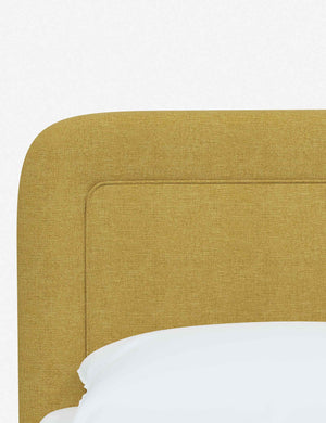 Close up of the rounded corners and interior welt border on the Gwendolyn Golden Linen Platform Bed