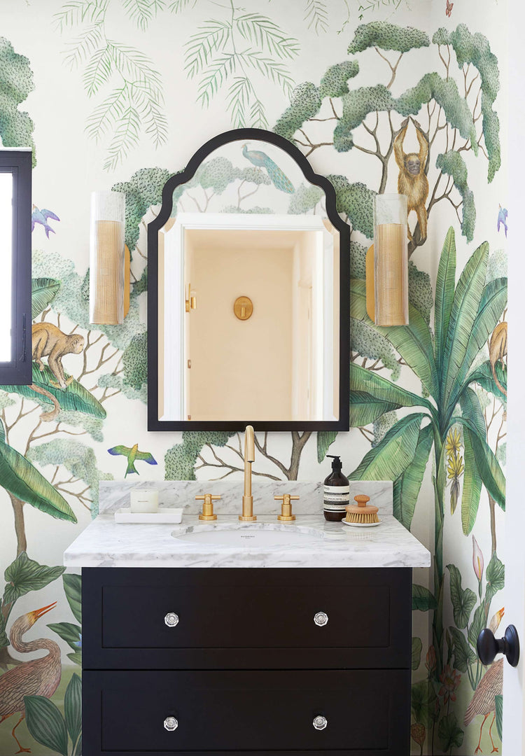 #color::green | Green Jungle Wallpaper Mural used in a powder room with a black mirror and black vanity.