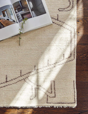 Close-up of the corner of the Rehya neutral geometric wool patterned rug