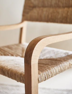 Close-up of the wooden arm on the Nolani woven rattan chair