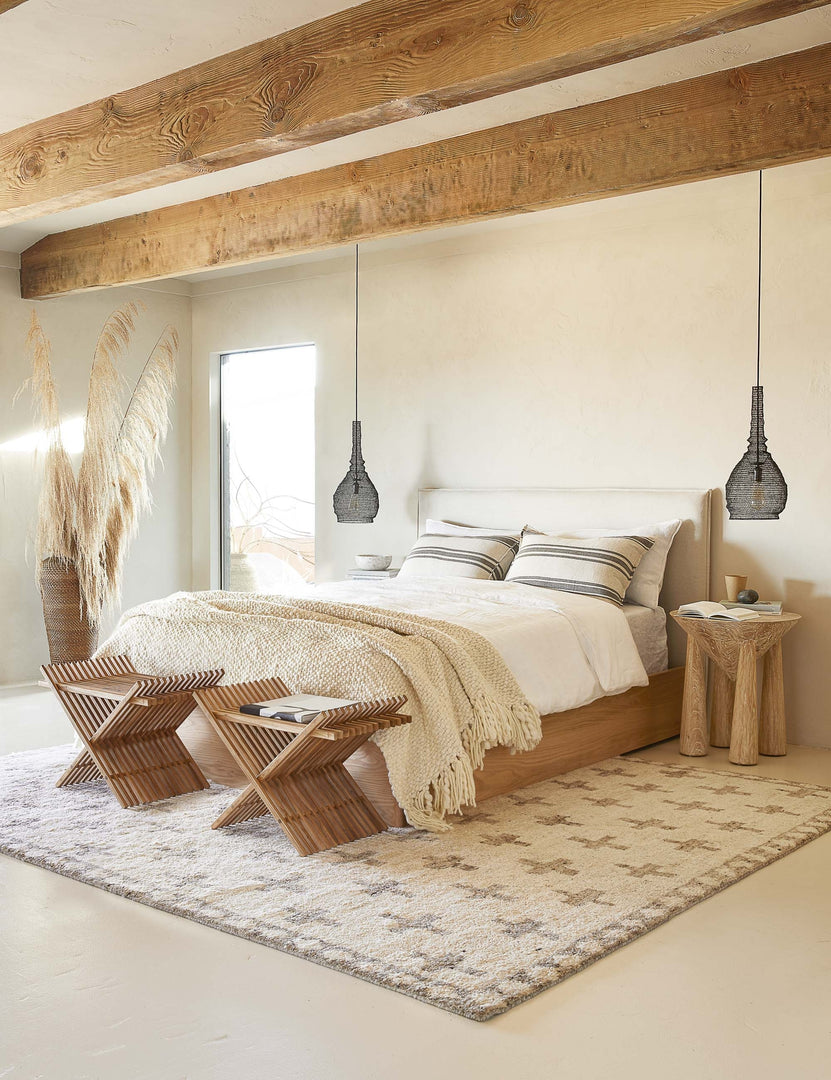 #color::flax-and-midnight #size::euro #size::king #size::standard | The Jackson Linen flax and midnight striped Sham by Pom Pom at Home lays on a natural linen and wood framed bed in a bedroom with a plush patterned rug, a sculptural wooden nightstand, and two black jute pendant lights