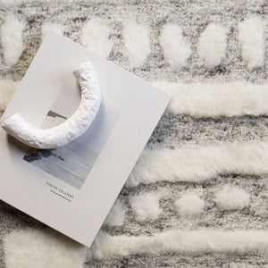 Bird's-eye view of the braeburn rug under a book and a sculptural object