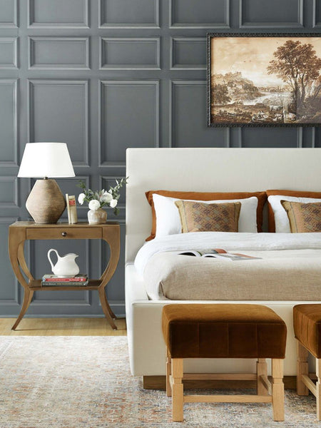 #color::oyster #size::cal-king #size::king #size::queen | The Lockwood white velvet-upholstered bed with a white oak base sits in a bright bedroom behind two cognac velvet ottomans underneath a landscape painting mounted against a gray-blue wall.