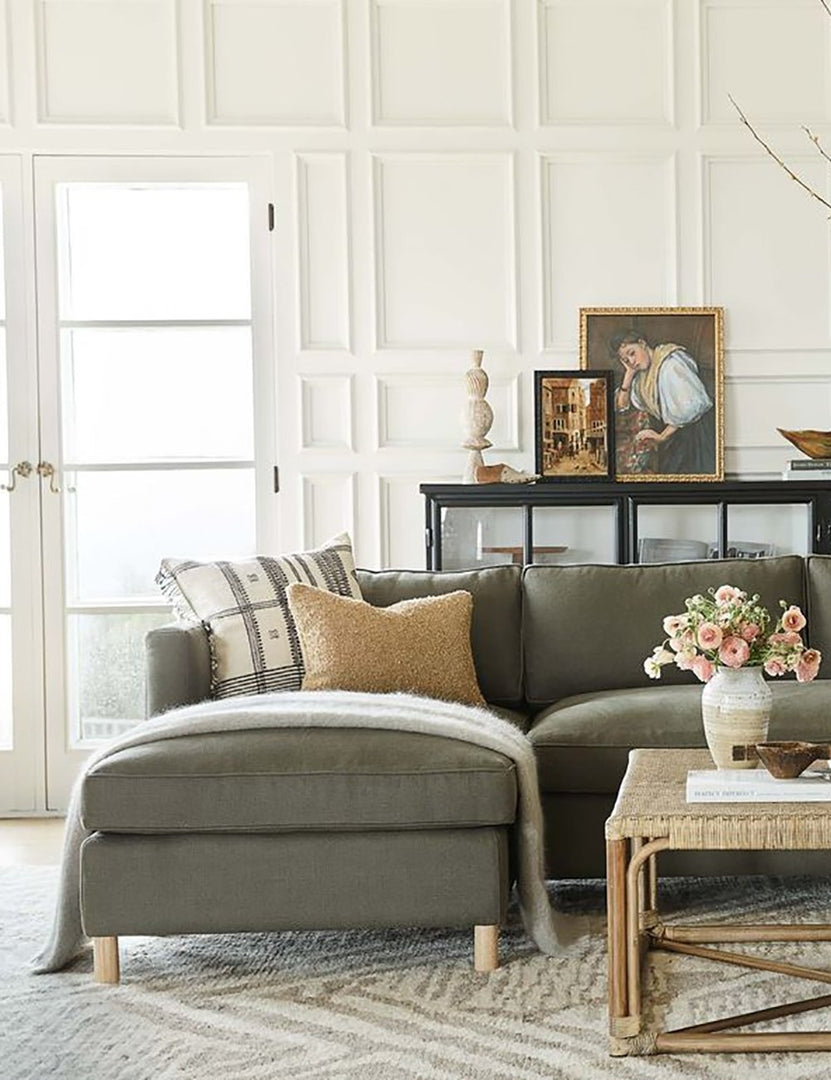 #color::loden #configuration::left-facing | The Belmont left-facing loden gray linen sectional sits atop a gray and white patterned carpet in a room with accented walls