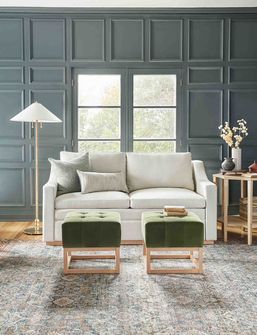 #size::king #color::natural #size::queen | Coniston Natural Linen Sleeper Sofa sits in a living room with green accented walls, two green velvet ottomans, and a patterned rug