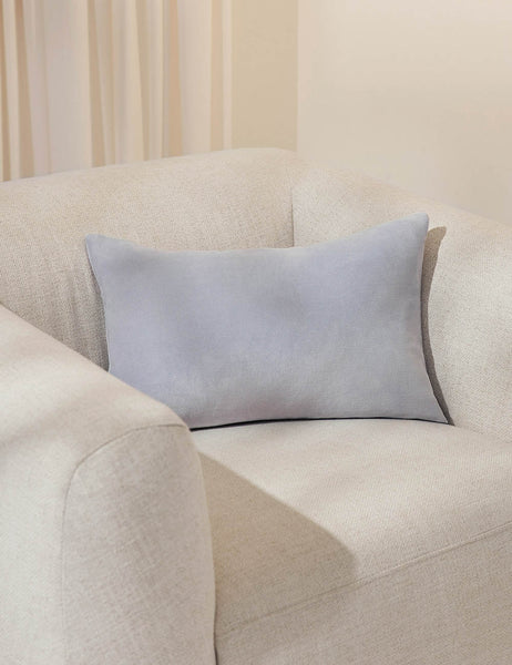 #color::ice-blue #size::13--x-20- #style::lumbar| Charlotte ice blue lumbar velvet pillow sits on a white accent chair with a white curtain in the background