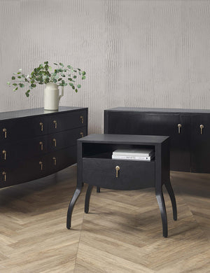 The Anabella black wood console table with silver drawer pulls sits in a room with the anabella nightstand and anabella dresser