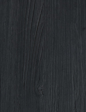 Wood grain of the Mags sculptural solid wood desk in black.