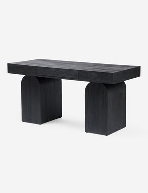 Angled view of the Mags sculptural solid wood desk in black.