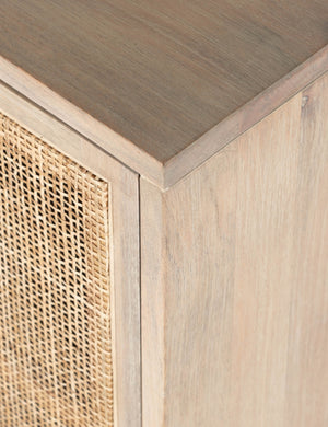 Detailed view of the upper corner of the Margot whitewashed natural mango wood sideboard with cane doors.