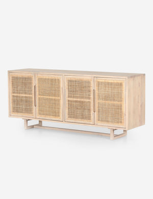Angled view of Margot whitewashed natural mango wood sideboard with cane doors.