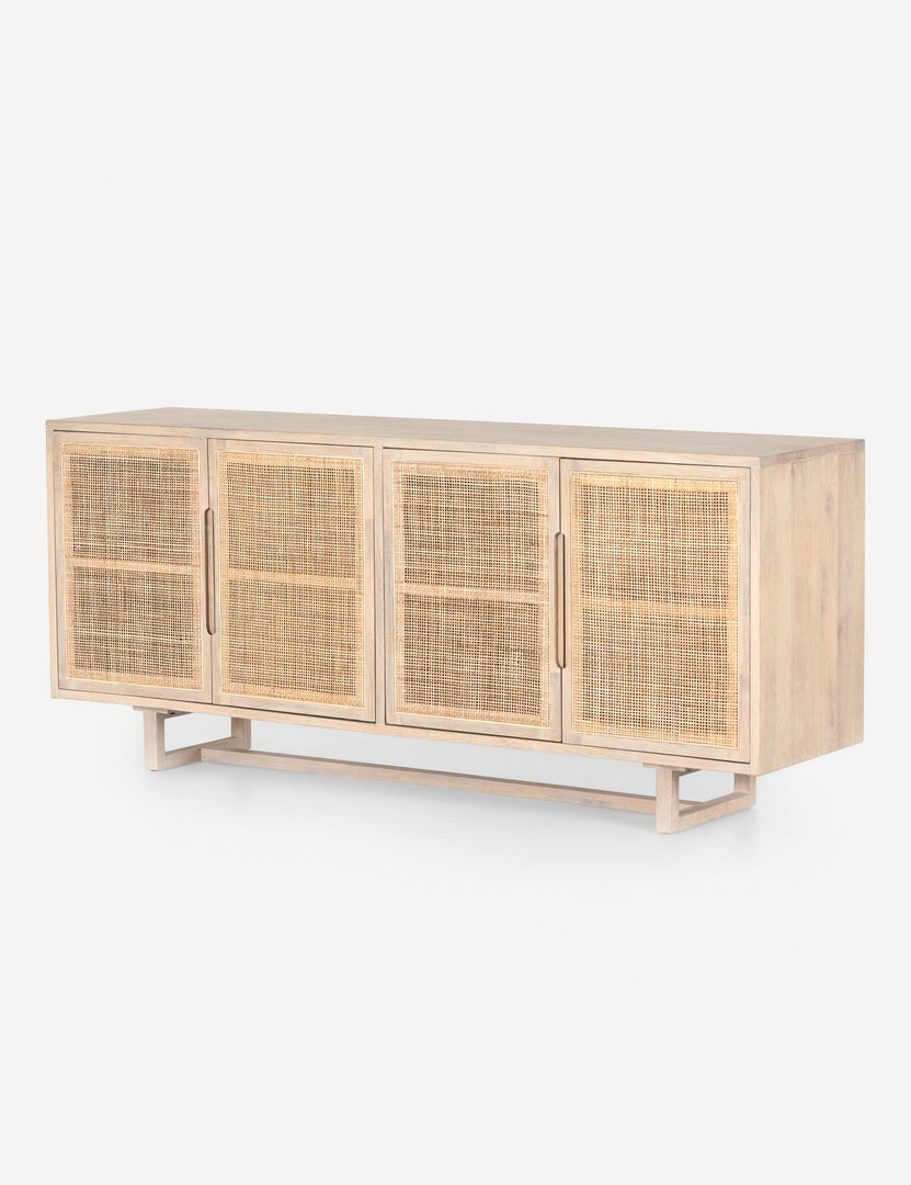 #color::whitewash | Angled view of Margot whitewashed natural mango wood sideboard with cane doors.