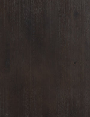 Detailed view of the black mango wood on the surface of the Margot black mango wood sideboard with cane doors.