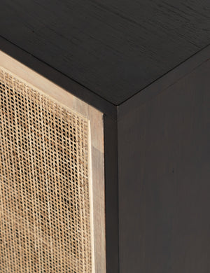 Close-up of the black mango wood and cane doors on the Margot black natural mango wood sideboard with cane doors.