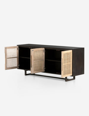 All four doors open on the Margot black natural mango wood sideboard with cane doors revealing the inner shelving.