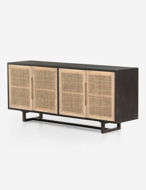 Angled view of Margot black natural mango wood sideboard with cane doors.