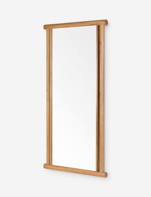 Angled view of the Alika oak wood dowel framed floor mirror.