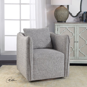 The Aisling swivel chair sits in a living room atop a natural rug in front of an ivory sideboard with accented doors