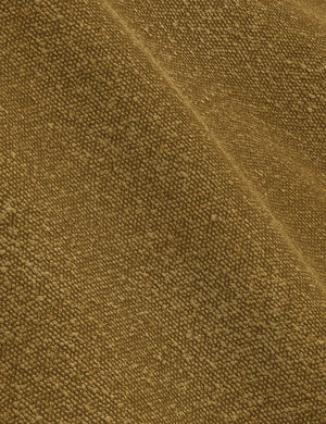 The ochre boucle fabric on the Nabiha platform bed