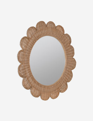 Angled view of Asha round scalloped wicker framed wall mirror