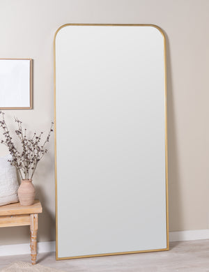 Homare slim, slightly rounded full length mirror leaning against wall