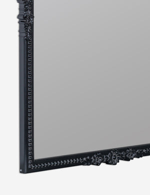 close up detail view of the bottom corner of the Cantara black rectangular floral detailed framed decorative wall mirror