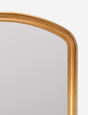 rounded top corner of the Oralie arched antique gold framed full length mirror