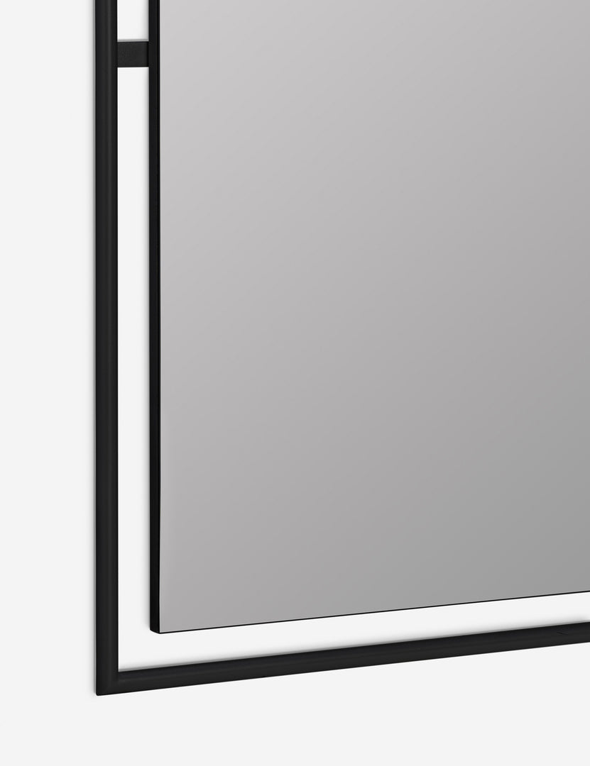 #color::black | close up of bottom corner of Shanti black metal framed decorative wall mirror