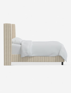 Side view of the Adara natural stripe linen upholstered bed.