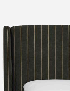Close-up of the subtle winged headboard and trim lines on the Adara peppercorn stripe linen upholstered bed.