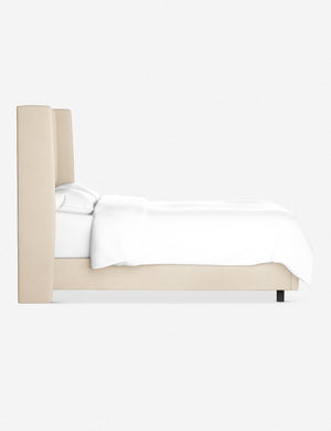 Side view of the Adara natural linen upholstered bed.