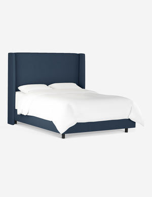 Angled view of the Adara navy linen upholstered bed.