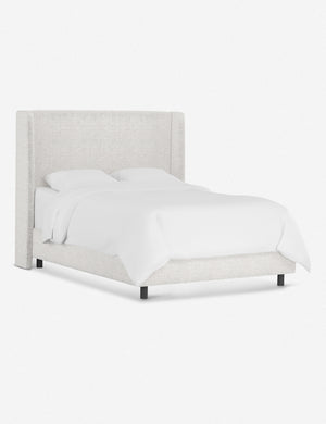 Angled view of the Adara white boucle upholstered bed.